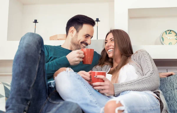 Cute young couple drinking coffee at home — Stock Photo, Image