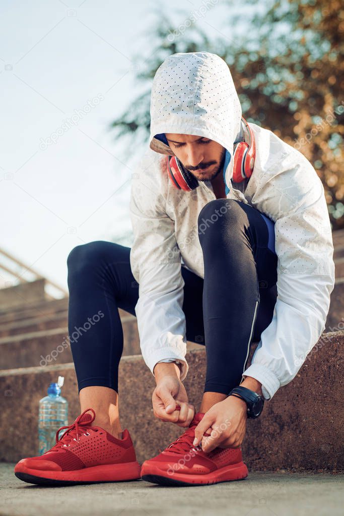 Man tying jogging shoes