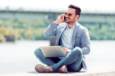 parkta dizüstü kullanan adam