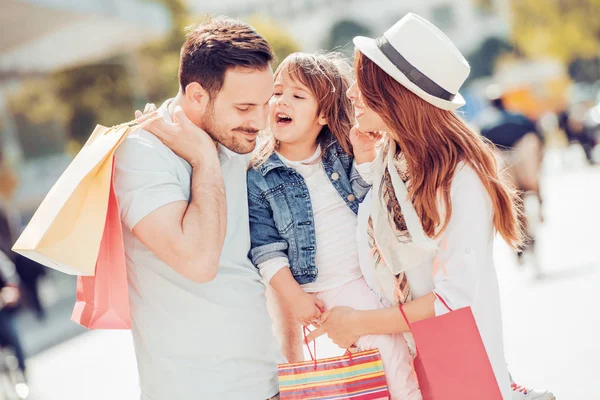 Happy family with shopping bags — Stock Photo, Image