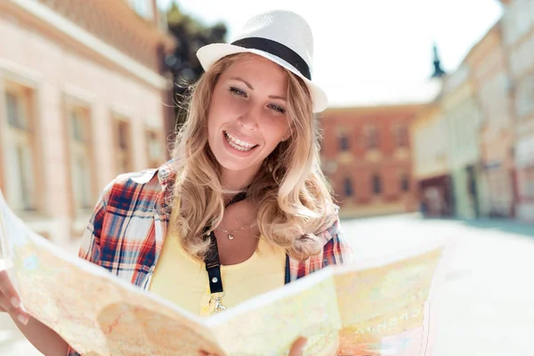 Woman tourist with map on the street