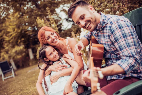 Family playing  guitar outdoors — Stock Photo, Image