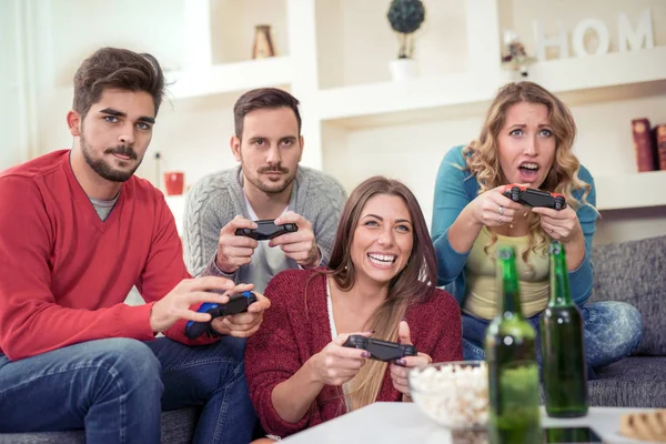 Friends having great time, playing video game together.