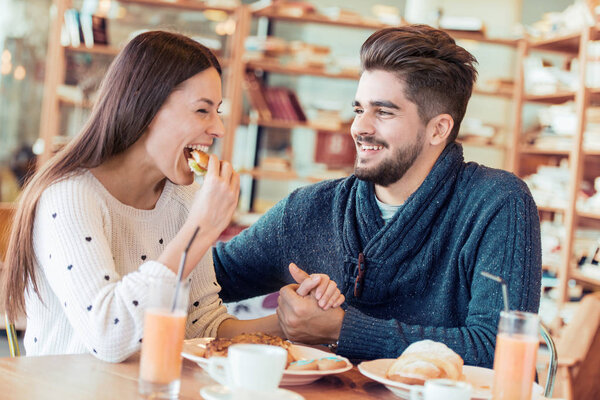 young couple enjoying breakfast 