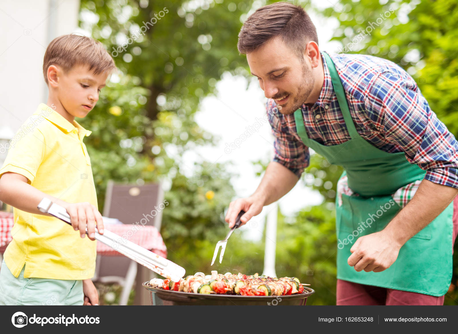Father And Son Preparing Barbecue Stock Photo C Ivanko1980