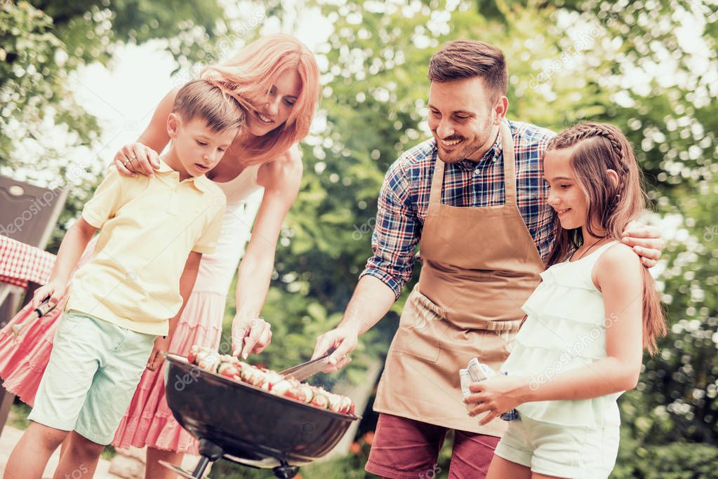 Happy family having barbecue