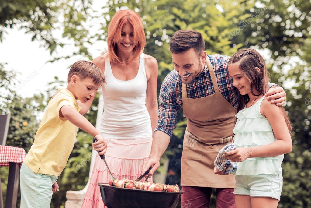 Happy family having barbecue