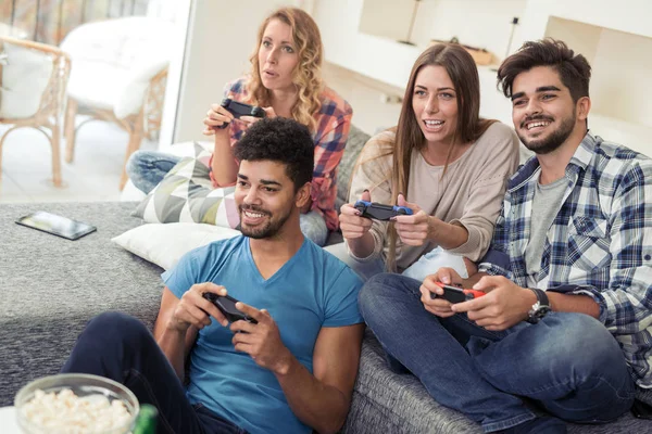 Friends playing video games at home