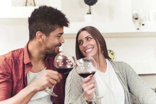 Beautiful couple is drinking wine,talking and smiling. — Stock Photo, Image