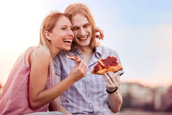 Couple eating pizza