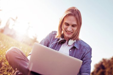 Genç adam dizüstü bilgisayar kullanıyor