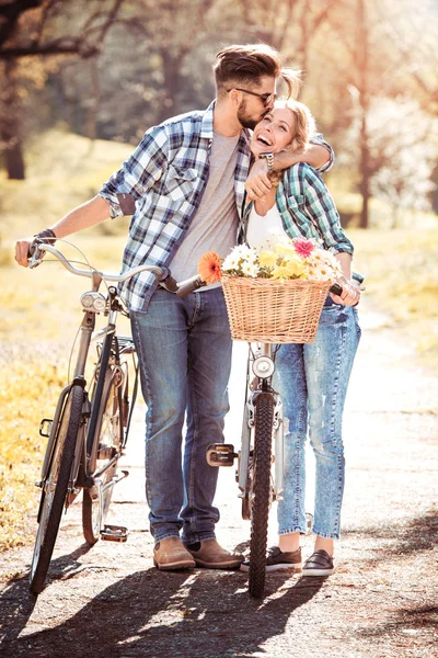 Verliebtes Paar im Park mit Fahrrad. — Stockfoto