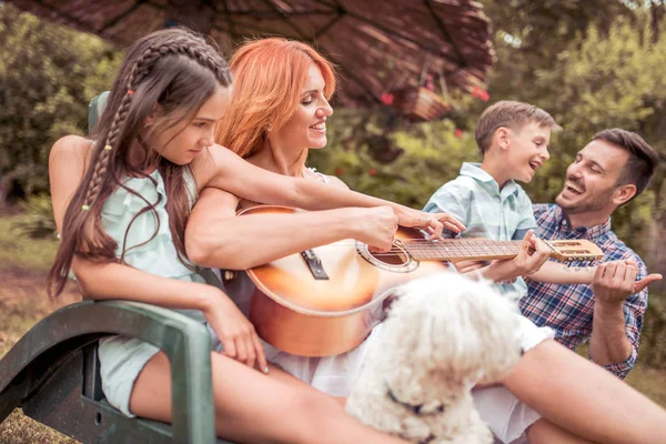 Happy Family Resting Garden Dog Playing Guitar — Stock Photo, Image