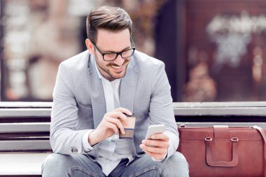 Modern adam açık havada cep telefonu kullanarak.