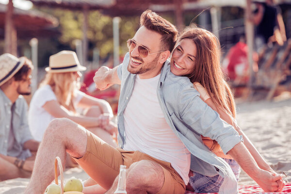 Romantic young couple on the beach,enjoying together.