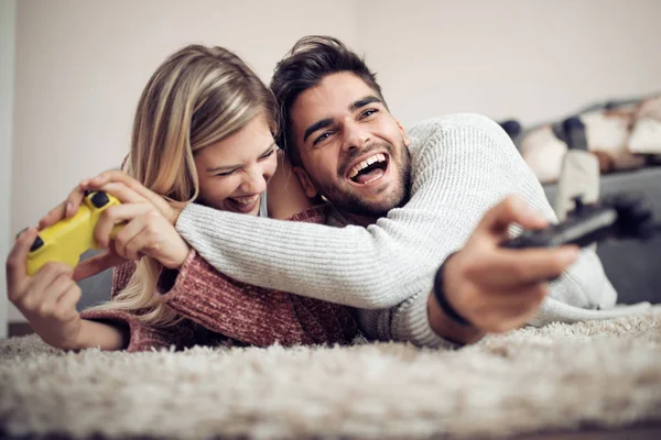 Happy couple having fun with new game consoles trends technology- Gaming,people and fun concept.