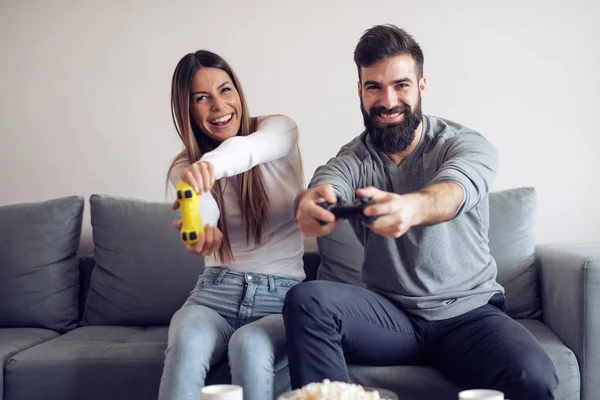 Happy couple having fun with new game consoles trends technology- Gaming,people and fun concept.