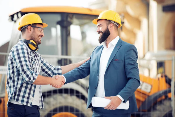 Two engineer have consulting meeting at construction site