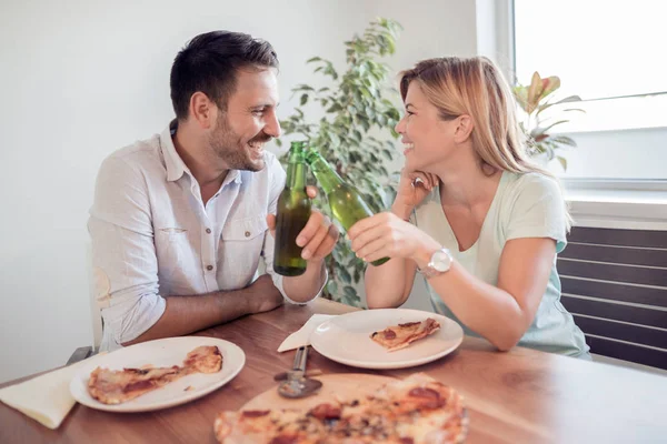 Молодая пара наслаждается пиццей . — стоковое фото