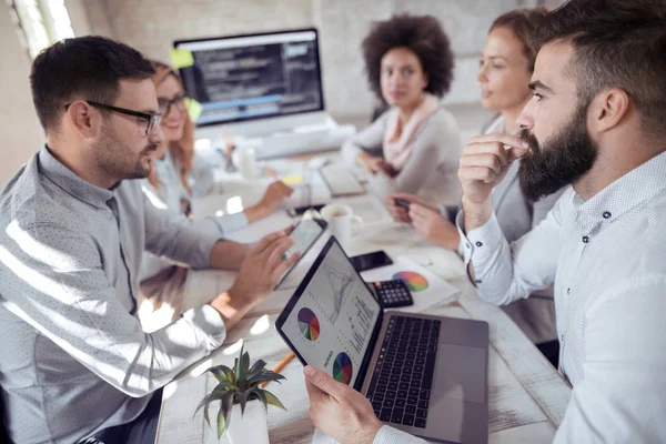 Business people giving some new ideas about project to his partners in conference room.