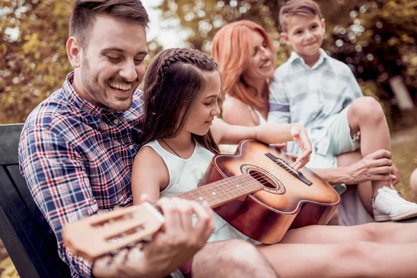 Young Family Enjoying Quality Time Playing Guitar Garden — Stock Photo, Image