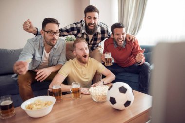 Futbol takımı evde destekleyen dostluk, spor ve eğlence kavramı mutlu erkek arkadaşlar.