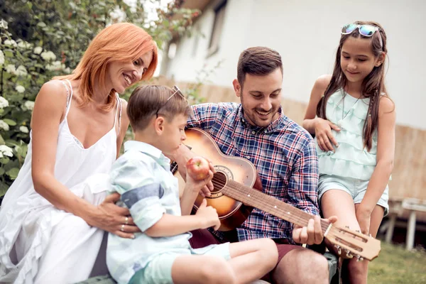 Young Family Enjoying Quality Time Playing Guitar Garden — Stock Photo, Image