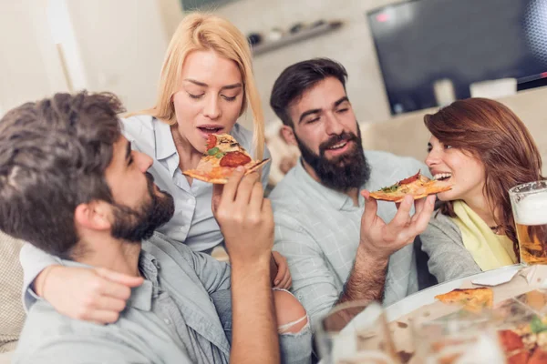 Sledování televize doma, zatímco jíst pizzu přátel — Stock fotografie