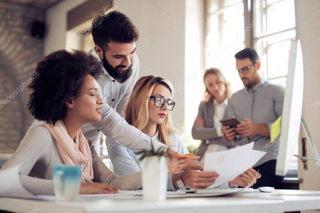 Group of businessmen working in bright office 