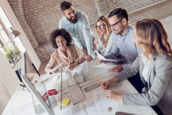 Group of businessmen working in bright office 