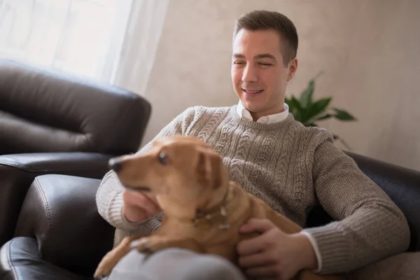 Happy Young Man Sitting Dog Sofa Home — Stock Photo, Image