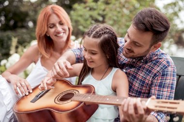 Kaliteli zaman zevk, gitar kendi bahçesinde oynayan genç aile.
