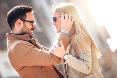 Mutlu genç çift dışarıda eğleniyor ve gülümsüyor..