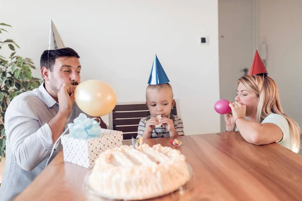 People,family and holidays concept-happy family blowing balloons at home.