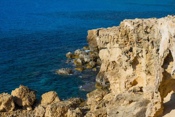 Cavo Greco cape on Cyprus. Travelling and vacation concept. Spectacular rocks on the Mediterranean Sea shoreline. Clean and blue cloudless sky.