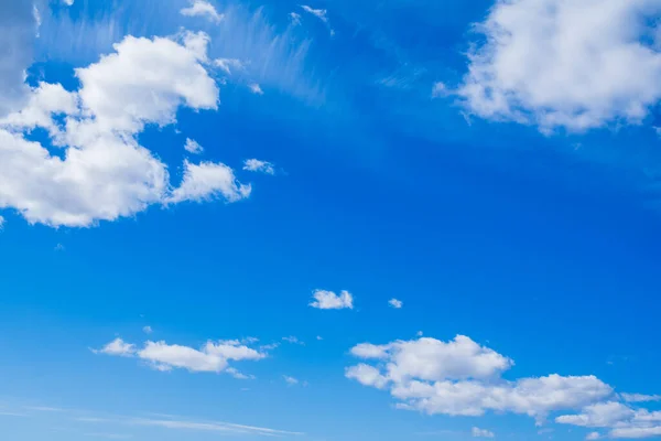 Clean blue limitless sky with clouds on summer day.