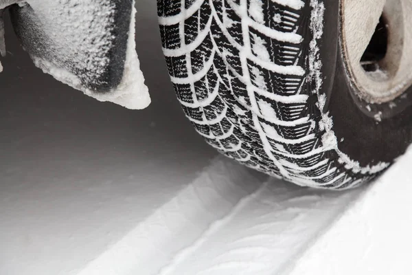 Close up of car tyre in winter covered with snow. Winter tyre in extreme cold temperature — Stock Photo, Image