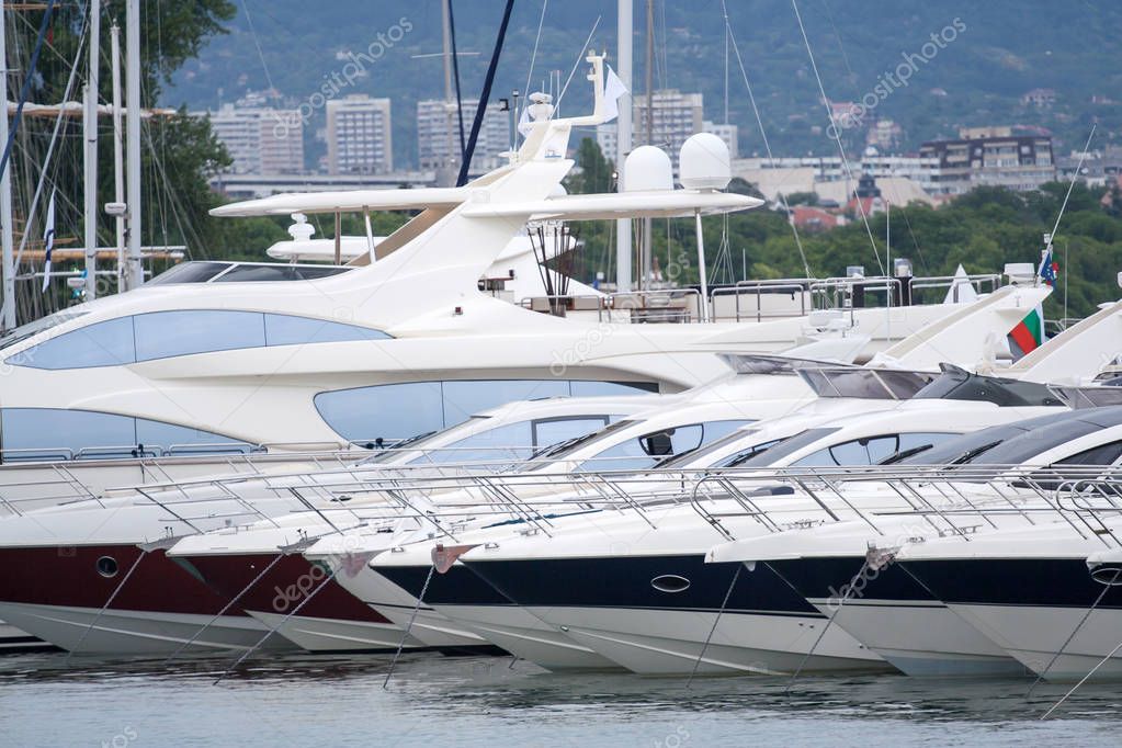 moored luxury yachts stand on an anchor