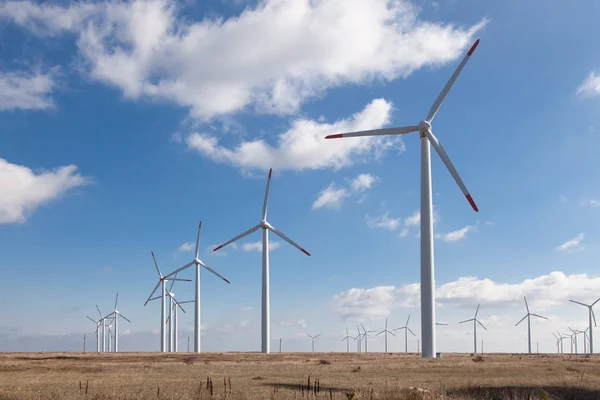 Wind turbine farm over the blue clouded sky — Stock Photo, Image