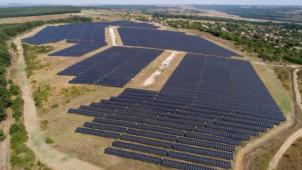 Aerial shot of photovoltaics solar farm. Solar farm power station from above. Ecological renewable energy. — Stock Photo, Image