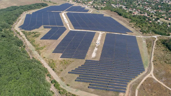 Aerial shot of photovoltaics solar farm. Solar farm power station from above. Ecological renewable energy. — Stock Photo, Image