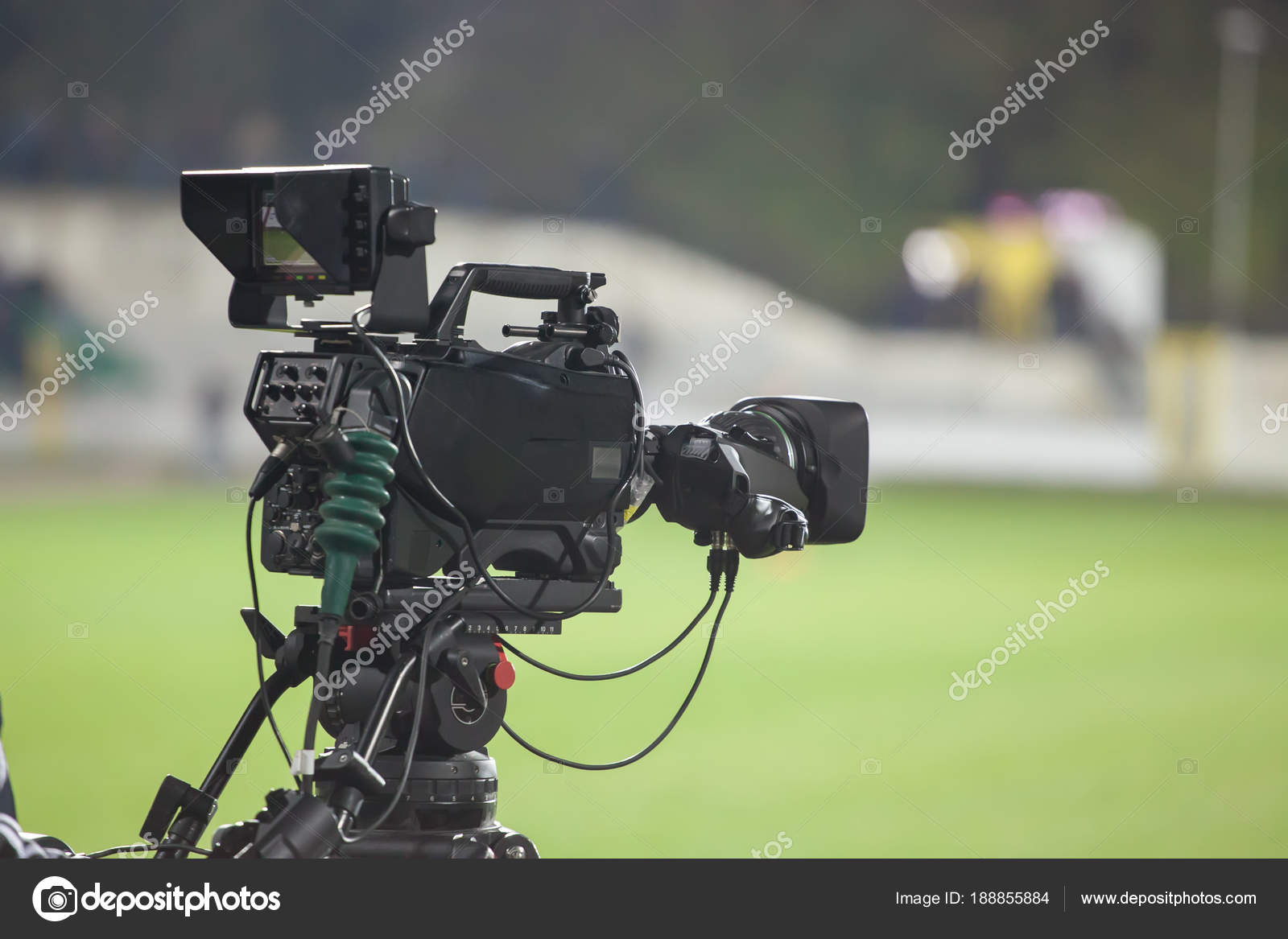 TV camera at the stadium, broadcasting during a football (soccer