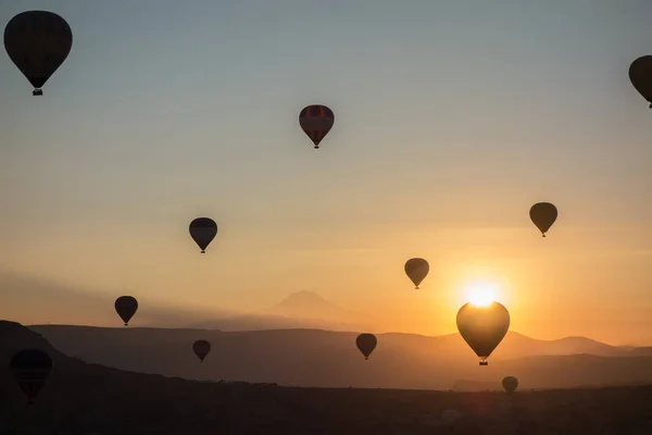 Az ég alatt napkelte hőlégballon. Repül át a völgy: Cappadocia, Anatólia, Törökország. A Göreme nemzeti park vulkanikus hegyek. — Stock Fotó