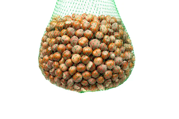 Green net with hazelnuts, isolated on white — Stock Photo, Image