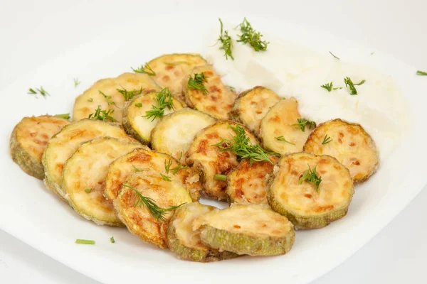 Fried zucchini with yogurt in white plate. — Stock Photo, Image