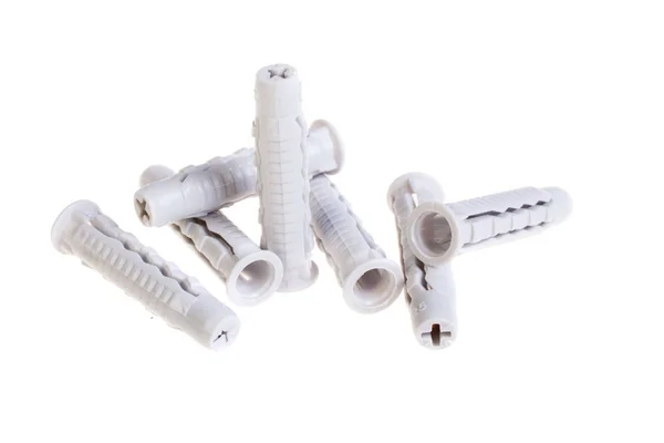 Багато пластикових дюбелів, ізольовані на білому. Гвинтовий анкер, будівельні інструменти — стокове фото