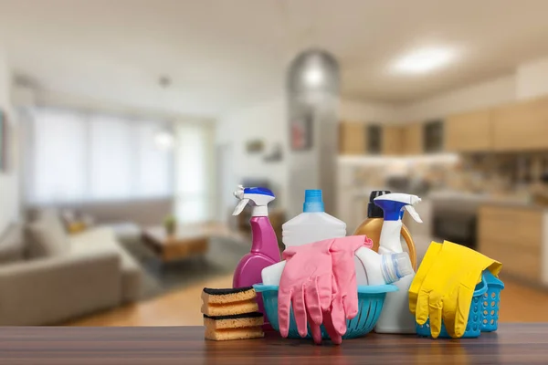 Home cleaning service concept with supplies. Close up of cleaning supplies in front of livingroom.