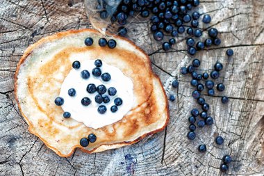Blueberry and berry pancake with sour cream
