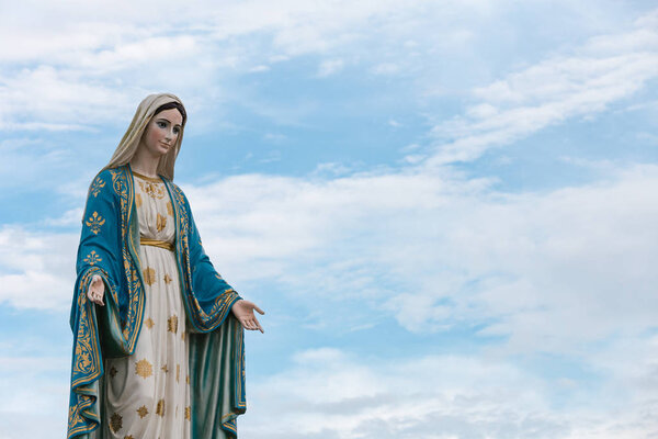 The Blessed Virgin Mary in the blue sky.