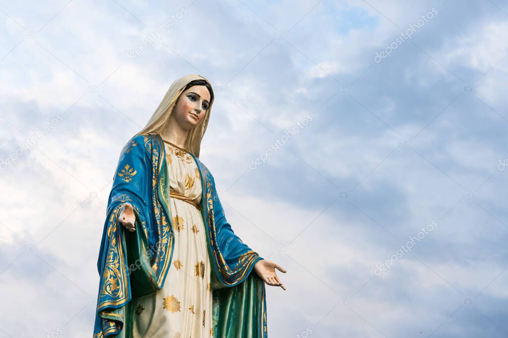 The Blessed Virgin Mary,mother of Jesus on the blue sky, in front of the Roman Catholic Diocese, public place in Chanthaburi, Thailand.